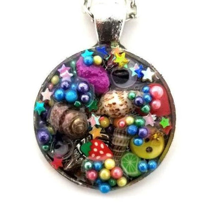 Resin pendant containing variety of unique found objects - Includes 18" chain - Curio Memento