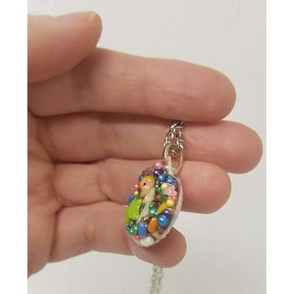 Seashell pendant created using antique miniature angel, candy sprinkles, sequins and resin. Includes 18" chain - Curio Memento