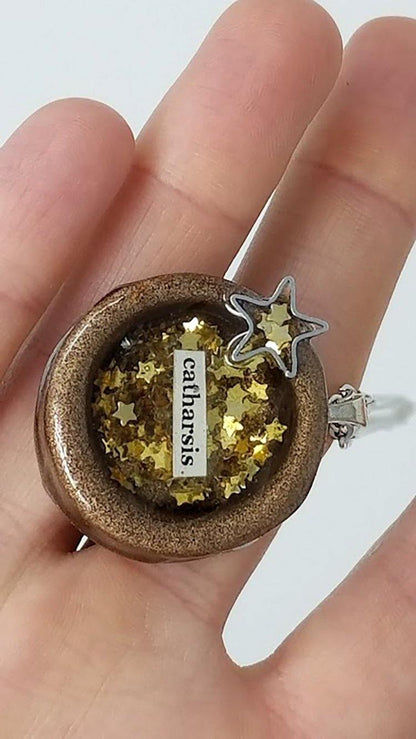 Round painted clay "catharsis" pendant filled with gold star sequins immersed in resin - Includes chain - Curio Memento