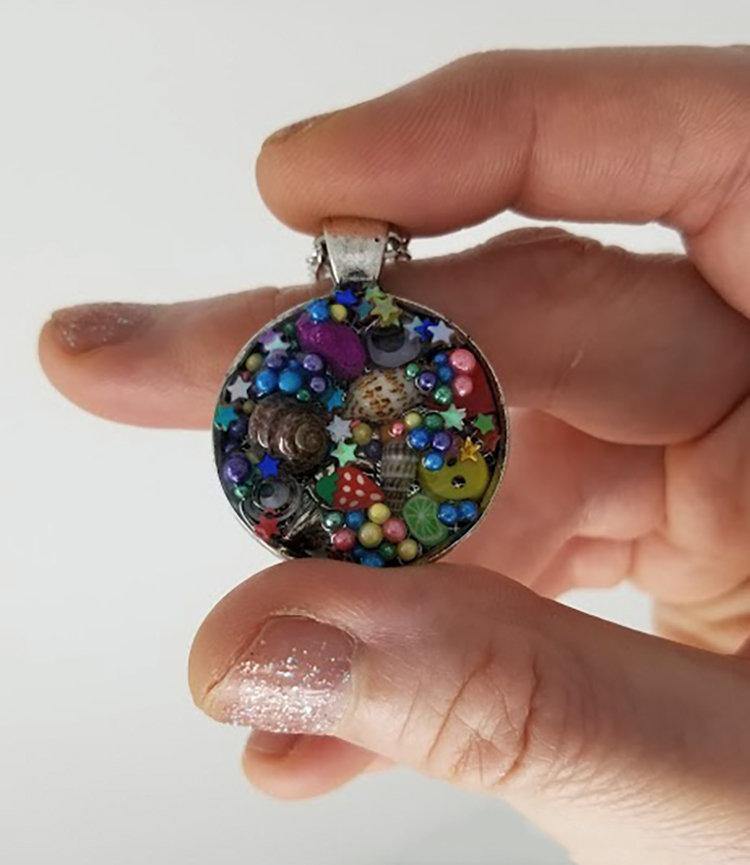 Resin pendant containing variety of unique found objects - Includes 18" chain - Curio Memento