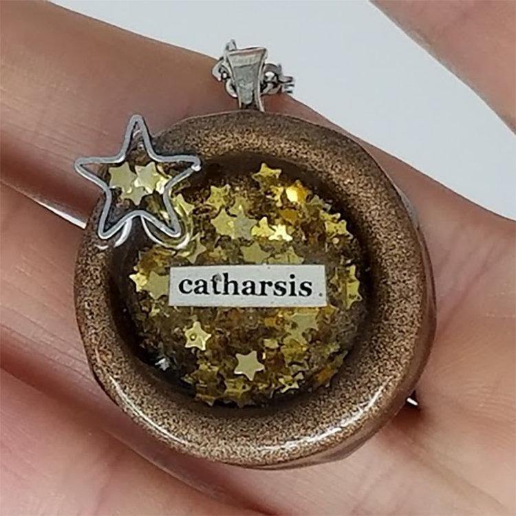 Round painted clay "catharsis" pendant filled with gold star sequins immersed in resin - Includes chain - Curio Memento