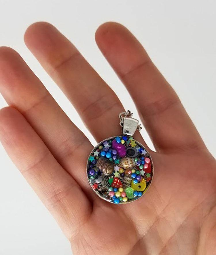 Resin pendant containing variety of unique found objects - Includes 18" chain - Curio Memento