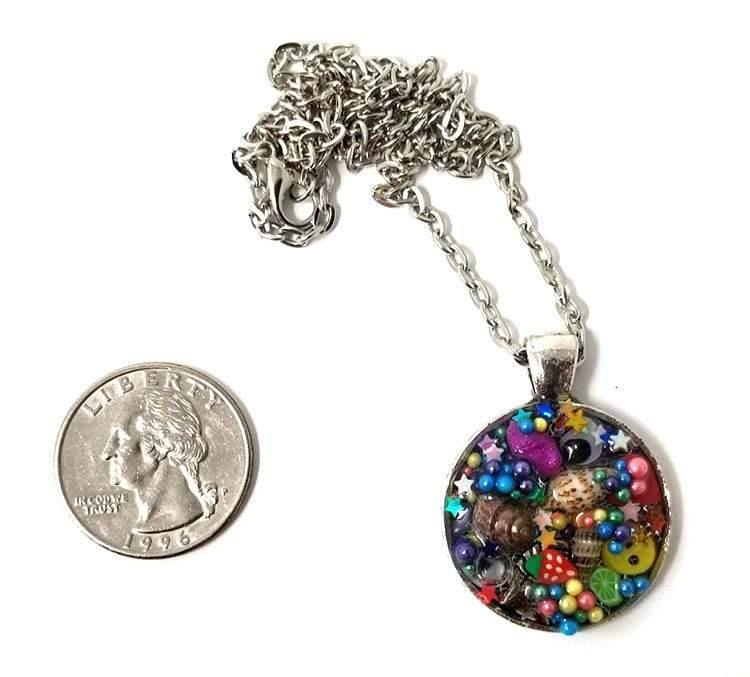 Resin pendant containing variety of unique found objects - Includes 18" chain - Curio Memento